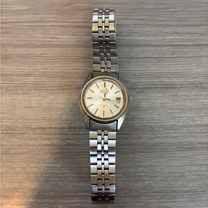 Vintage Seiko automatic watch with a silver dial and metal bracelet.